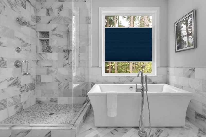 Bathroom with bathtub and shower in new luxury home with all gla