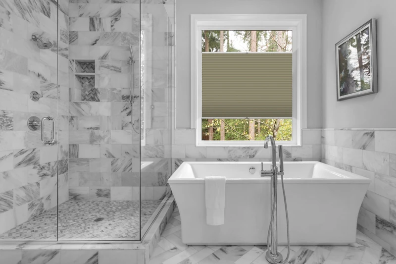 Bathroom with bathtub and shower in new luxury home with all gla