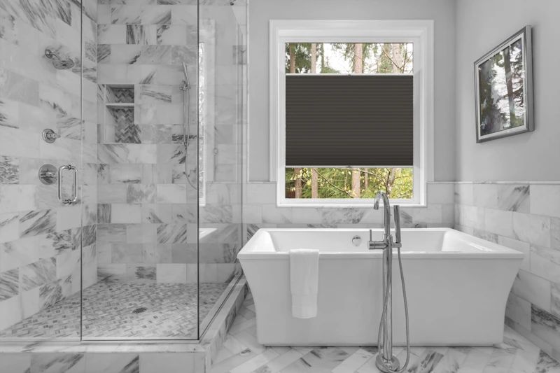 Bathroom with bathtub and shower in new luxury home with all gla