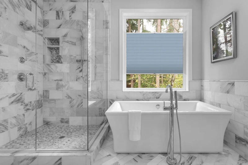 Bathroom with bathtub and shower in new luxury home with all gla