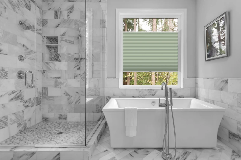 Bathroom with bathtub and shower in new luxury home with all gla