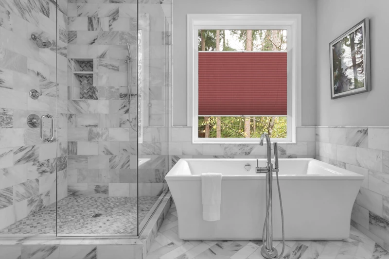 Bathroom with bathtub and shower in new luxury home with all gla