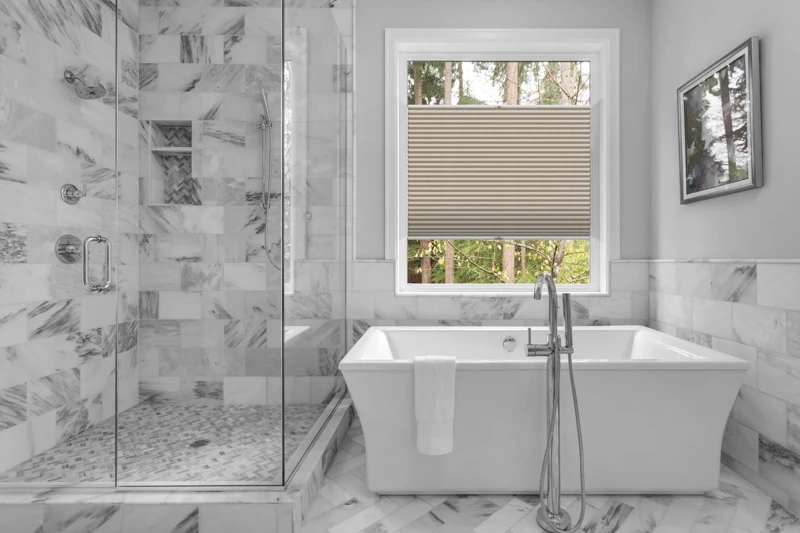 Bathroom with bathtub and shower in new luxury home with all gla