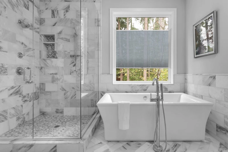 Bathroom with bathtub and shower in new luxury home with all gla